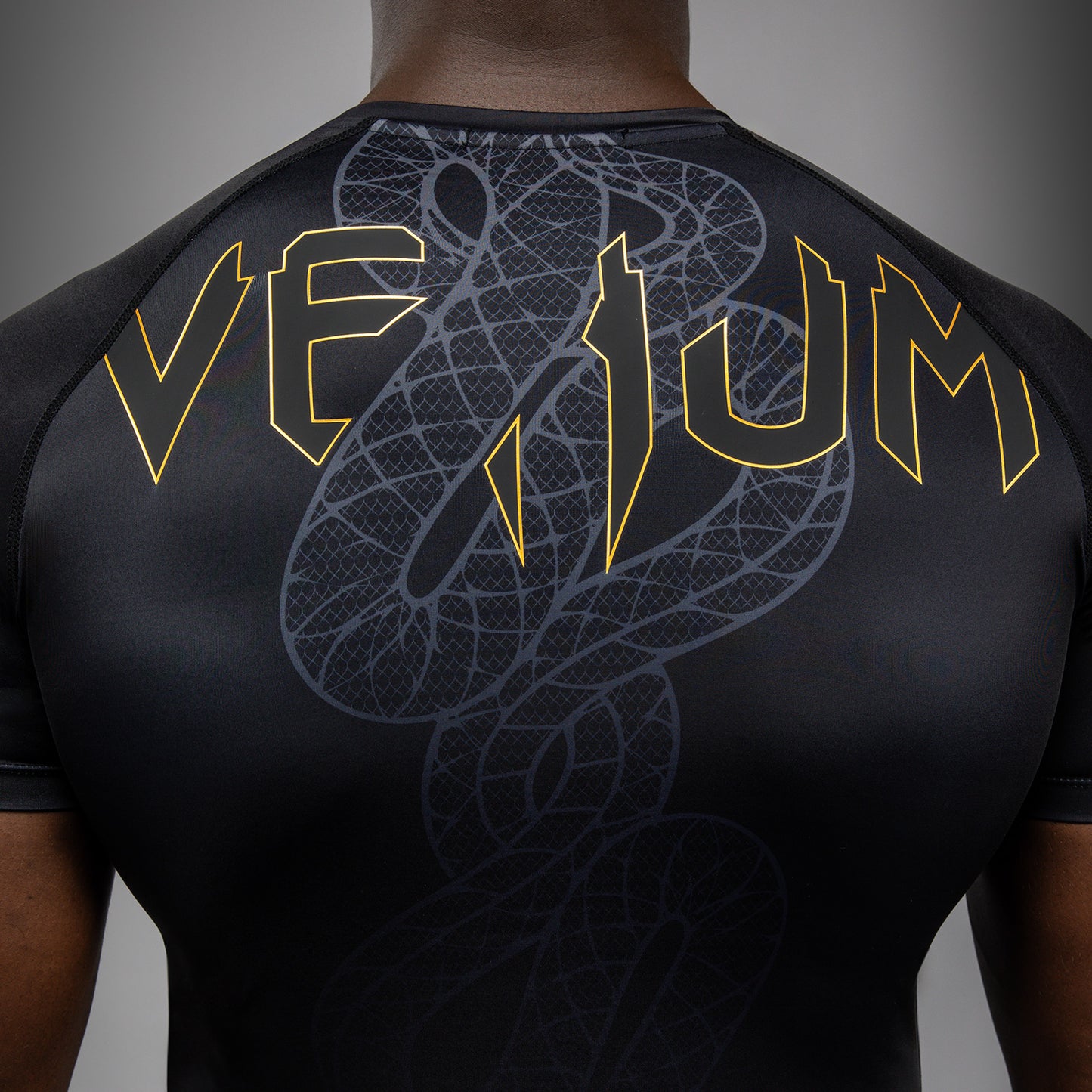 Venum Serpenti Short Sleeve Rashguard - Black/Silver/Gold